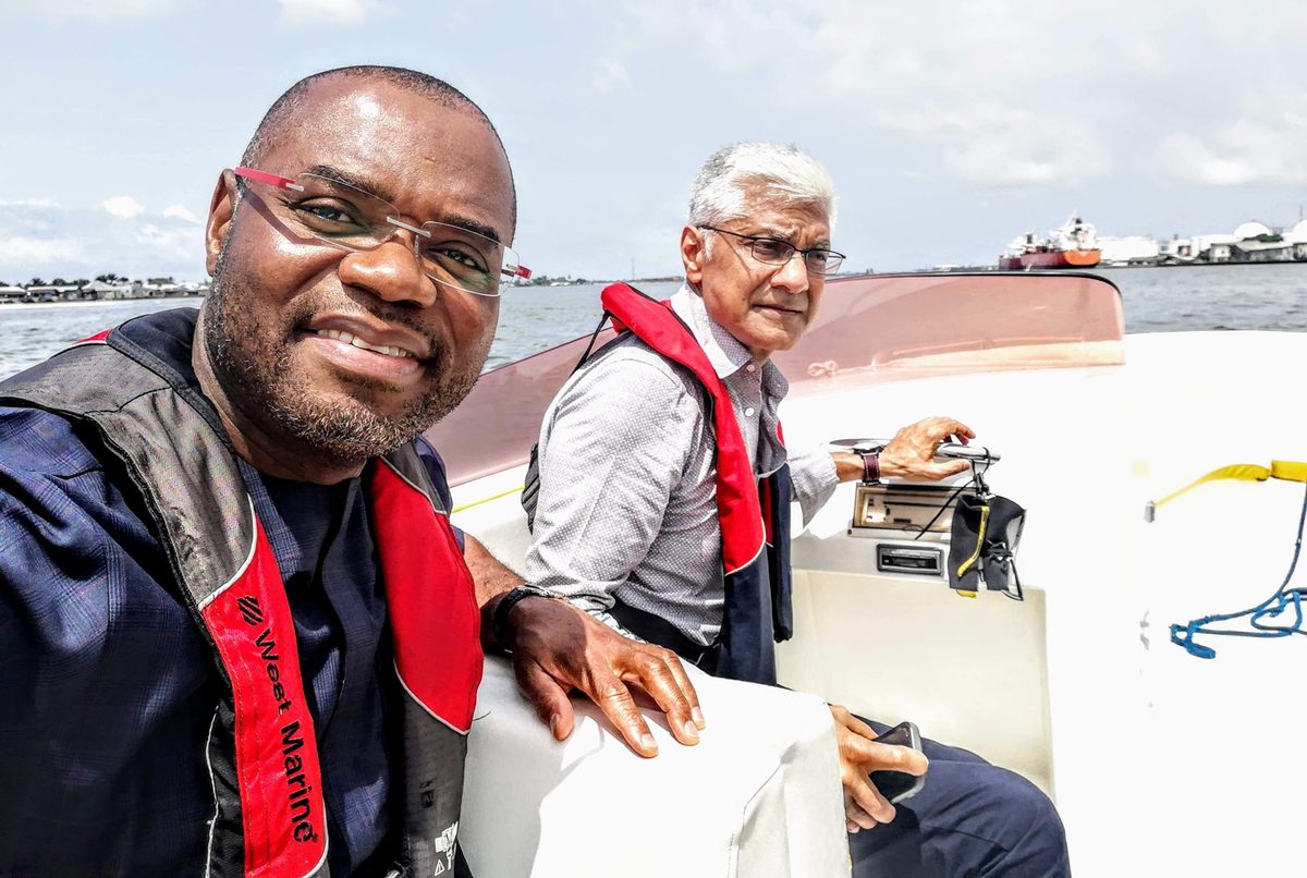 Jerome Okolo and Devendra Dave on the Lagos lagoon inspecting LPG import terminals