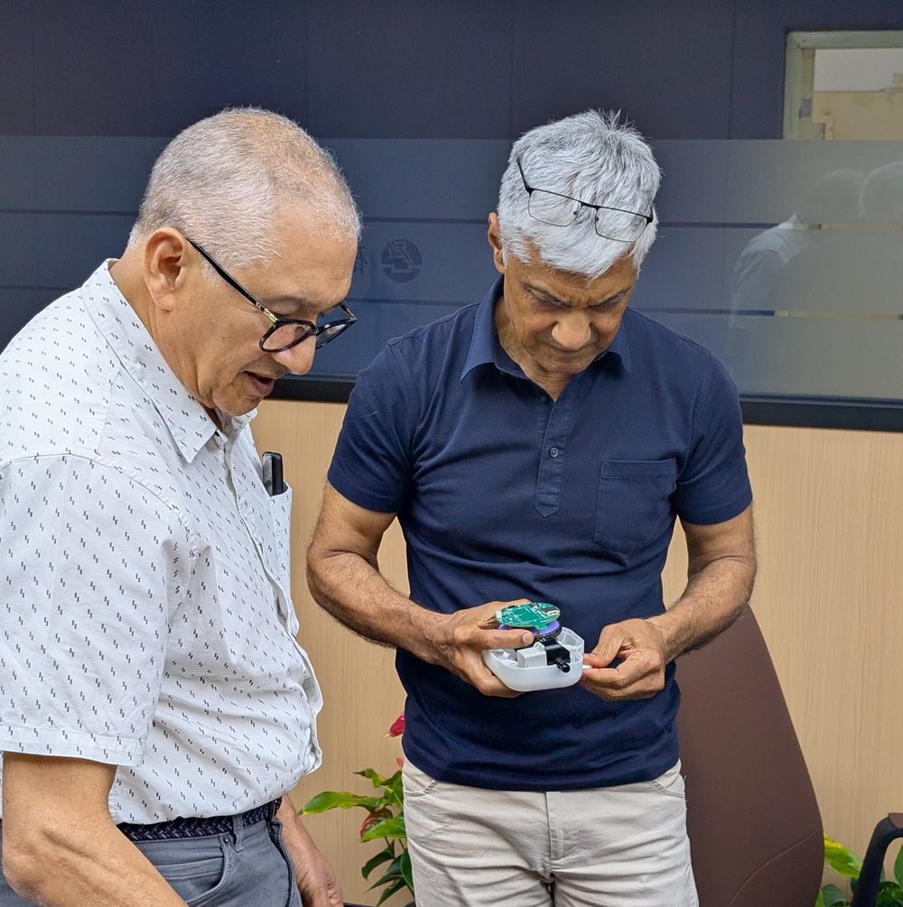 Alfredo Choperena and Devendra Dave examining a Kibo circuit board