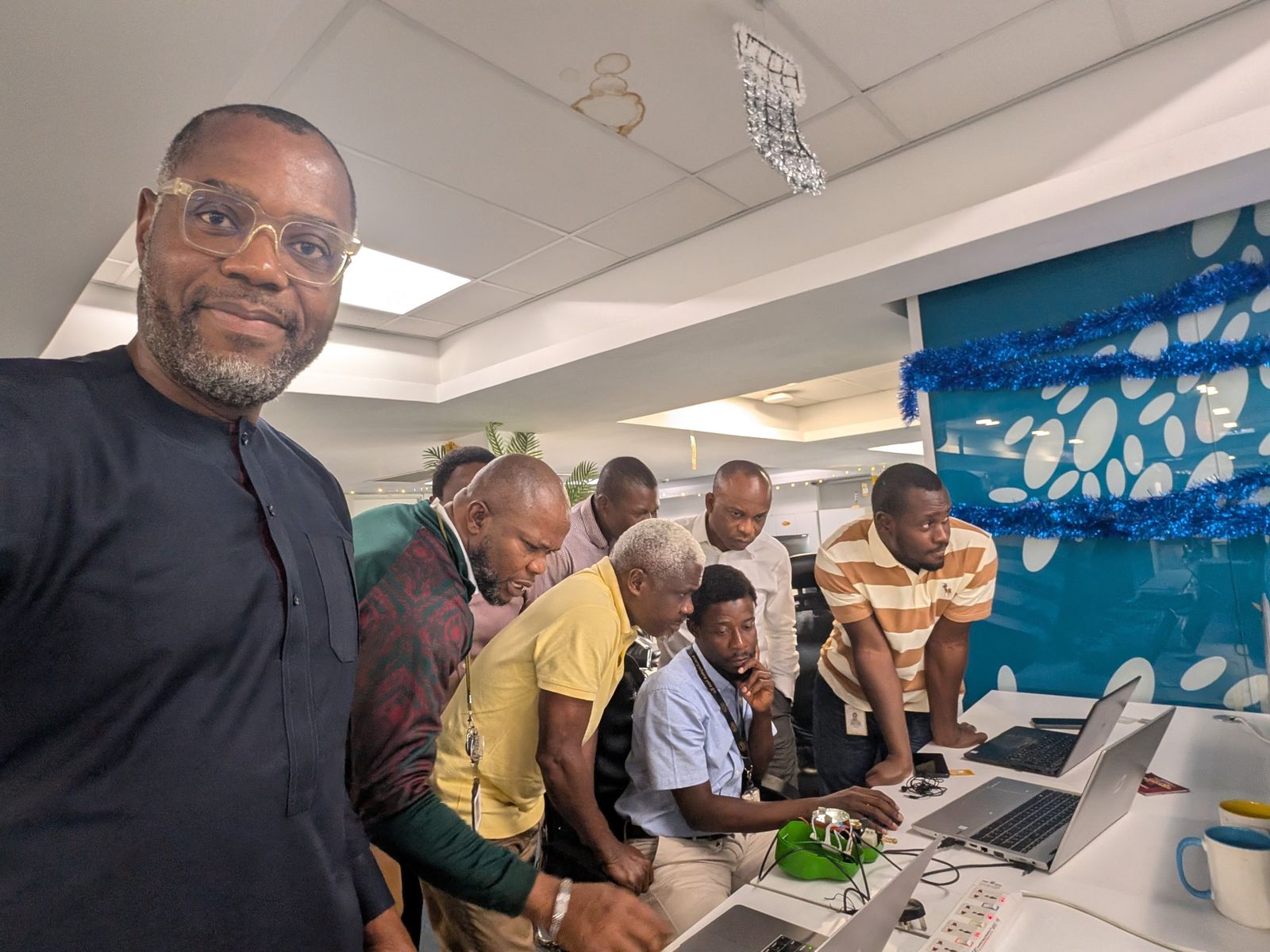 The joint MTN and Safi engineering team gathered around a laptop with a Kibo meter at MTN's Lagos offices