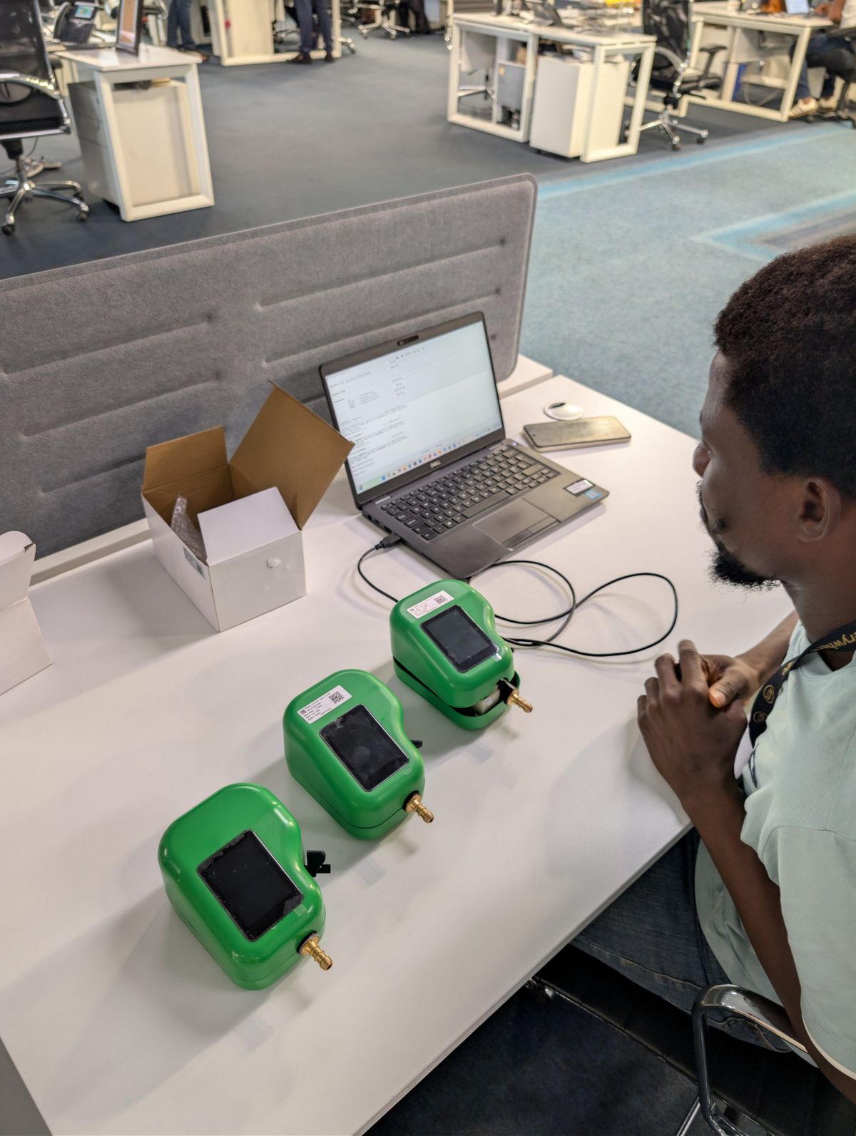Three Kibo meters lined up on a desk during integration testing