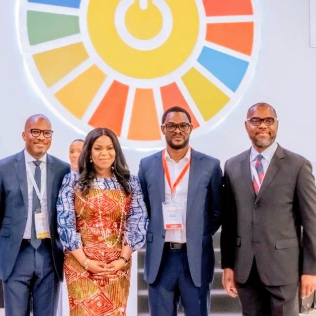 Jerome Okolo with fellow delegates in front of the SEforALL emblem at the Kigali forum